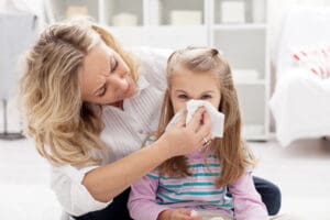 Child with allergy symptoms needing air duct cleaning in Lynchburg after renovation