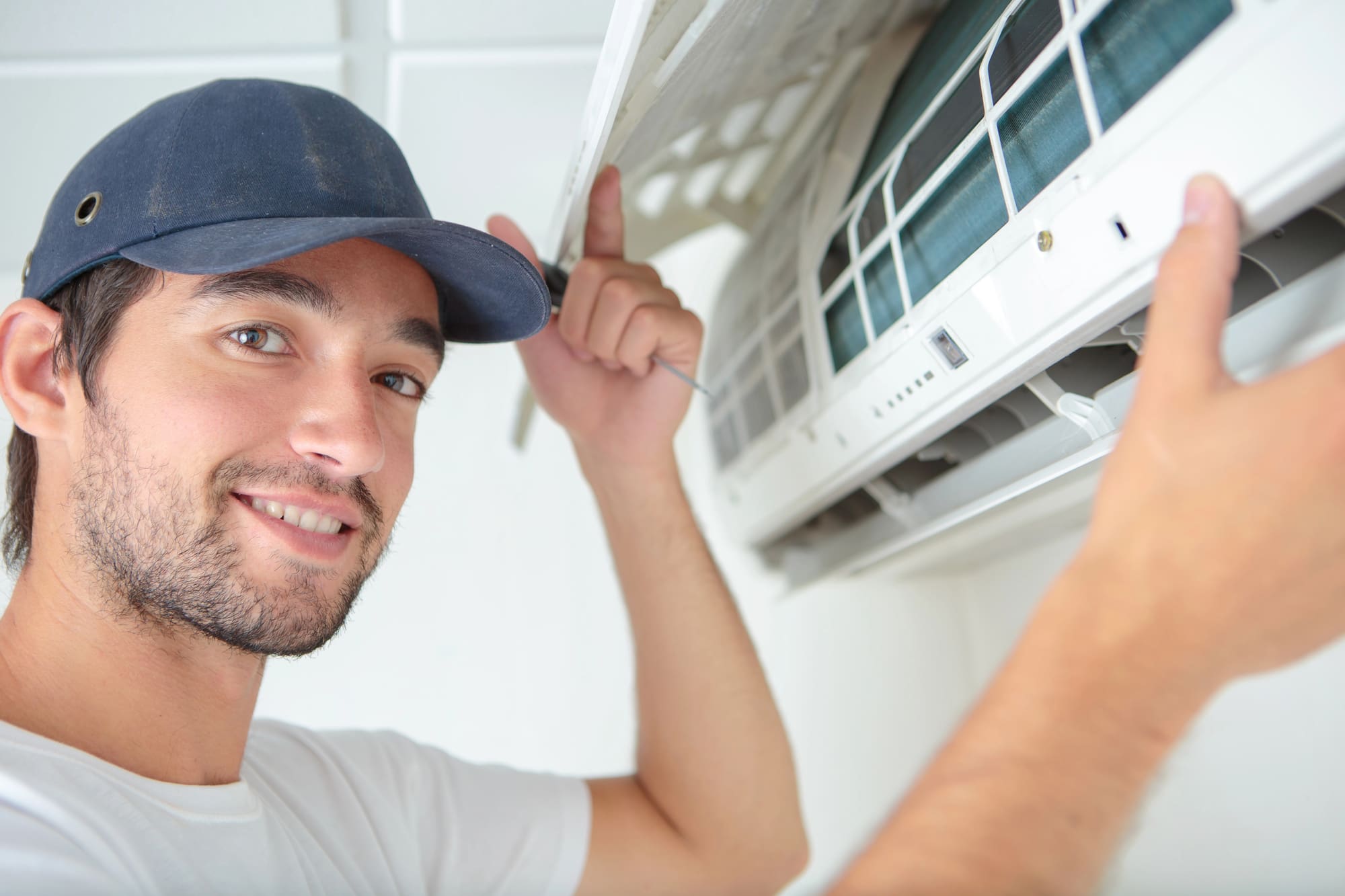 air conditioning system replacement Lynchburg energy efficient Professional technician performing air conditioning system replacement Lynchburg residents trust with a smile.